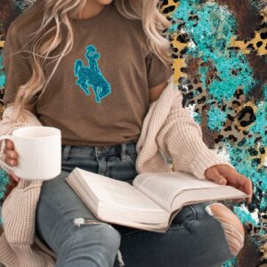 Shop Wyoming Teal the Sun Goes Down Glitter Steamboat ~ Heather Brown Bella Tee