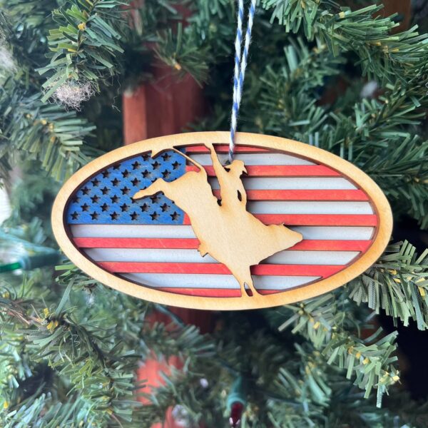 Shop Wyoming Patriotic Bull Rider Ornament – 4″ Oval Wood Rodeo Christmas Ornament with American Flag Background for Cowboy & Western Decor