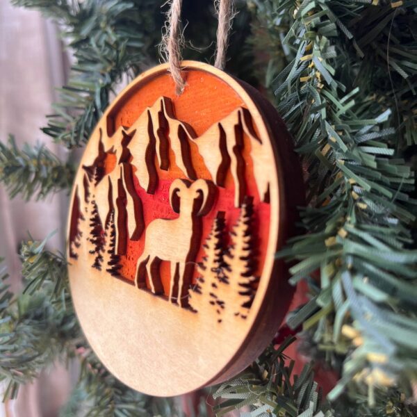 Shop Wyoming Mountain Goat Ornament – Bighorn Sheep Wooden Christmas Ornament – Nature-Inspired Outdoor Holiday Decor – Layered Sunset Forest Ornament 3.25″