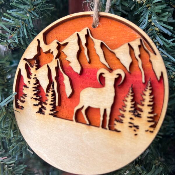 Shop Wyoming Mountain Goat Ornament – Bighorn Sheep Wooden Christmas Ornament – Nature-Inspired Outdoor Holiday Decor – Layered Sunset Forest Ornament 3.25″