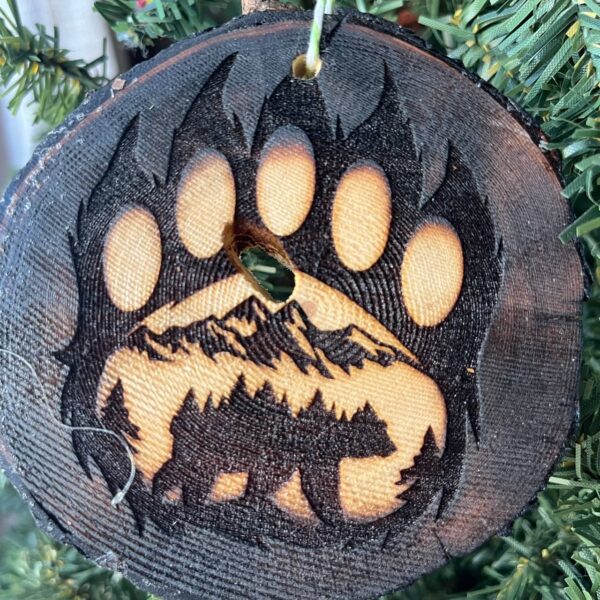 Shop Wyoming Bear Paw Print Engraved Pine Wood Ornament – Rustic Wildlife Tree Slice Décor – Locally Sourced 3.25″-4″ Round Ornament for Nature Lovers