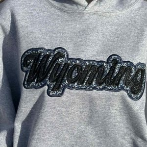 Shop Wyoming Wyoming black sparkles with blue western applique Embroidery Hoodie Shop Wyoming Wyoming black sparkles with blue western applique Embroidery Hoodie